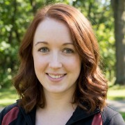 Smiling young woman with hazel eyes and long red hair